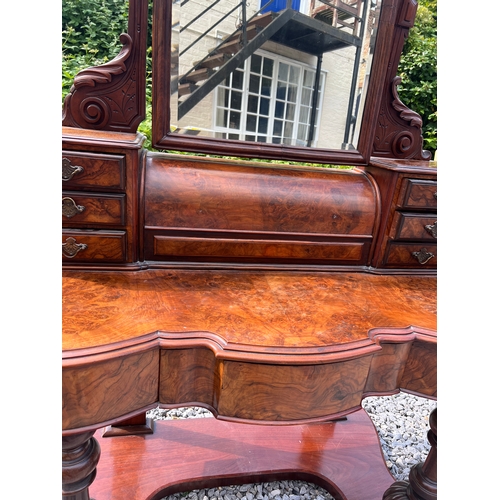 74 - A 19thC figured burr walnut dressing table with frieze drawers, swivel mirror, seven drawers to top ... 