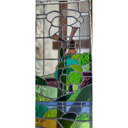 5B - Two stained glass windows depicting church and windmill. Each 94 x 40cm. Not now in frames.