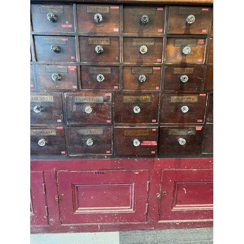 64 - Nineteenth century drug run/drawers, multiple drawers over cupboards to base. 268cm l x 137cm h x 30... 