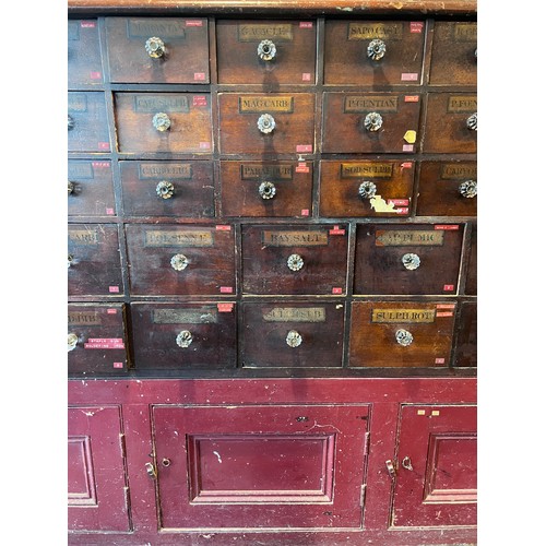 64 - Nineteenth century drug run/drawers, multiple drawers over cupboards to base. 268cm l x 137cm h x 30... 