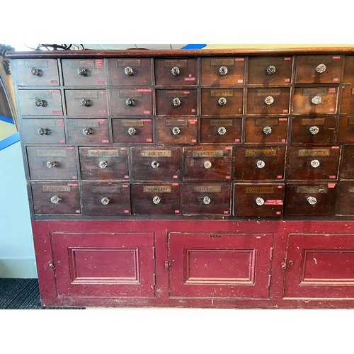 64 - Nineteenth century drug run/drawers, multiple drawers over cupboards to base. 268cm l x 137cm h x 30... 