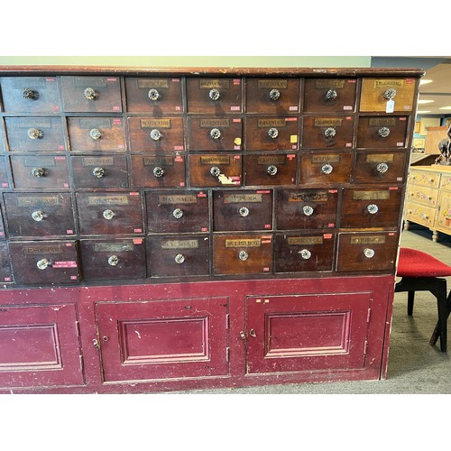 64 - Nineteenth century drug run/drawers, multiple drawers over cupboards to base. 268cm l x 137cm h x 30... 