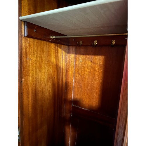 140 - A Edwardian mahogany inlaid compactum/wardrobe with mirrored doors to either side of central cupboar... 