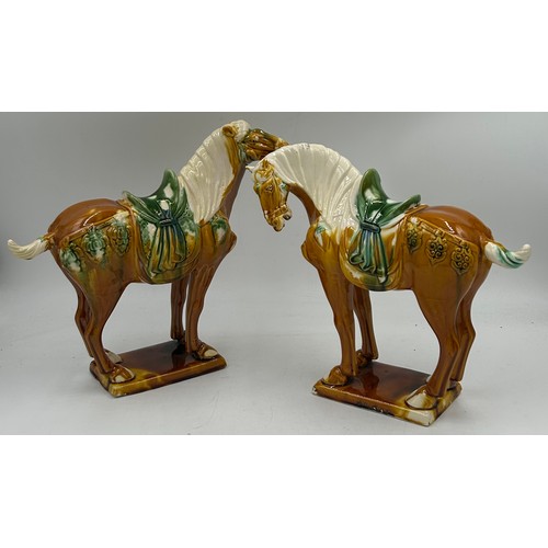 51 - A pair of 20thC Chinese Tang dynasty style horses 28cm h.