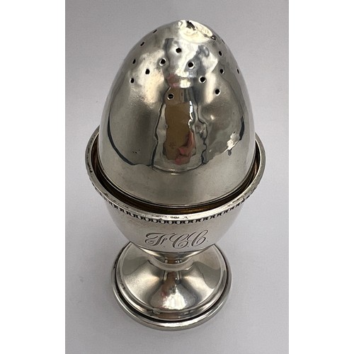 22 - Hallmarked silver egg cup, Birmingham 1947, 6cm h together with an egg shaped pepper pot with weight... 