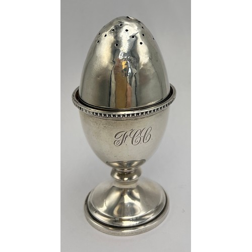 22 - Hallmarked silver egg cup, Birmingham 1947, 6cm h together with an egg shaped pepper pot with weight... 