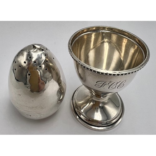 22 - Hallmarked silver egg cup, Birmingham 1947, 6cm h together with an egg shaped pepper pot with weight... 