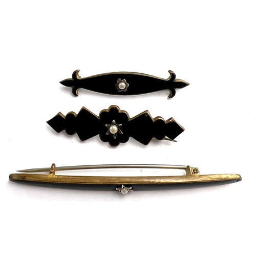 80 - Three Victorian black enamel mourning brooches, each set with a single seed pearl. Length of longest... 