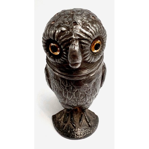 107 - A 19thC pewter pounce pot in the form of an owl with glass eyes. 8cm h.