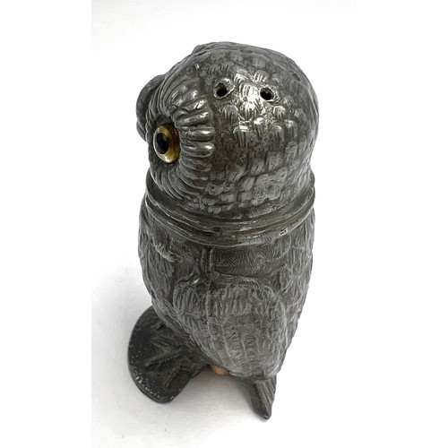 107 - A 19thC pewter pounce pot in the form of an owl with glass eyes. 8cm h.