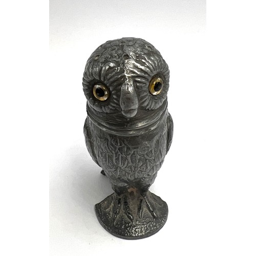 107 - A 19thC pewter pounce pot in the form of an owl with glass eyes. 8cm h.