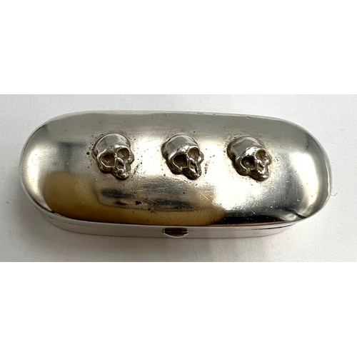 178 - A continental .800 silver ‘Memento Mori’ box with three skulls to the top and cream silk lining to t... 