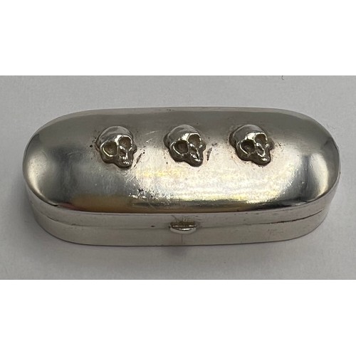 178 - A continental .800 silver ‘Memento Mori’ box with three skulls to the top and cream silk lining to t... 