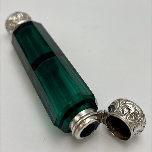 194 - A Victorian double ended green glass scent bottle with embossed white metal ends. 12cm l.