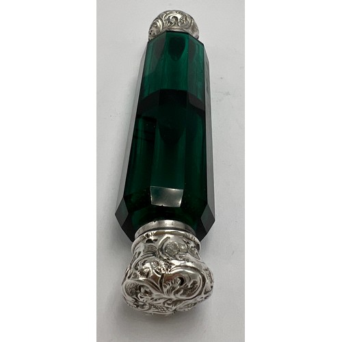 194 - A Victorian double ended green glass scent bottle with embossed white metal ends. 12cm l.