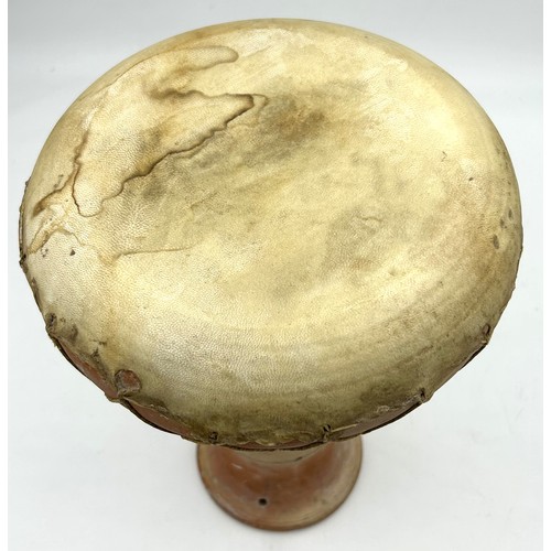 223 - A 1970’s African terracotta bongo drum. 33cm h.