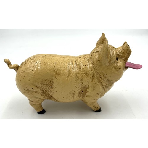 253 - A vintage cast iron pig money box. 20cm l.