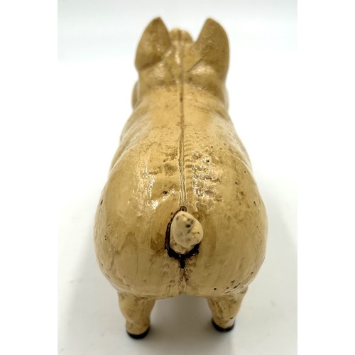 253 - A vintage cast iron pig money box. 20cm l.