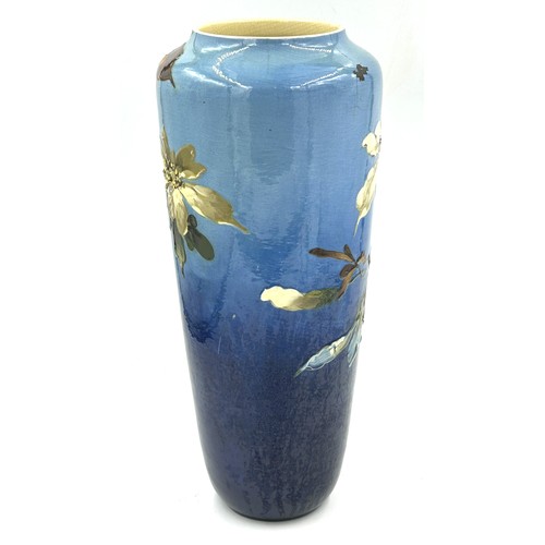 283 - A late 19thC Leeds Art vase with floral decoration on a blue ground. 42cm h.