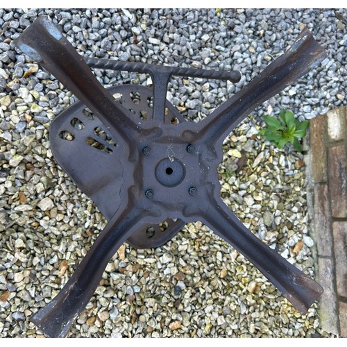 310 - Two cast iron tractor seat stools with adjustable swivel tops.