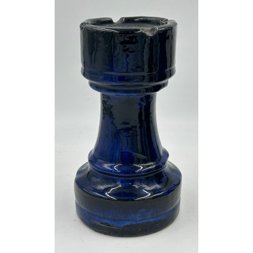 311 - A set of four oversized terracotta chess pieces in electric blue glaze. Tallest 36cm.