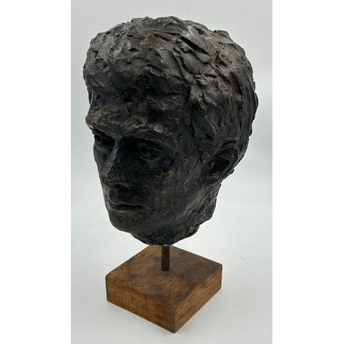 352 - A 1960’s plaster bust of president JFK, mounted on a wooden stand. 43cm h.