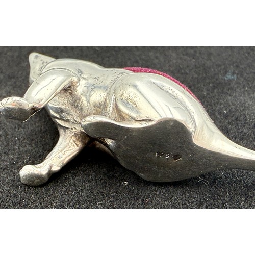 312 - A scratching cat sterling silver pincushion. 6cm l.