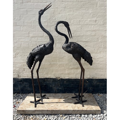 931 - A pair of Japanese bronze cranes on later marble base. Height 132cm.