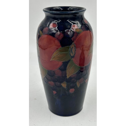 343 - Two Moorcroft vases in the Pomegranate pattern monogram and impressed marks to base, one with sticke... 