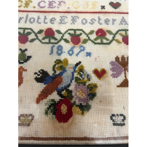 866 - A framed sampler by Charlotte E Foster Aged 11 1869, frame 42 x 31cm.