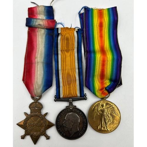 1002 - Medals and badges : a trio group of the 1914/1915 Star, George V British War medal, and Victory meda... 