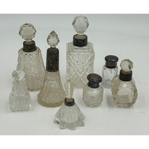 774 - A collection of 5 silver topped/collared scent bottles and 3 others. Tallest 14.5cm. Most a/f.