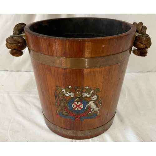 1172 - An oak naval fire bucket with insignia to the front, two copper bands and a rope handle with leather... 