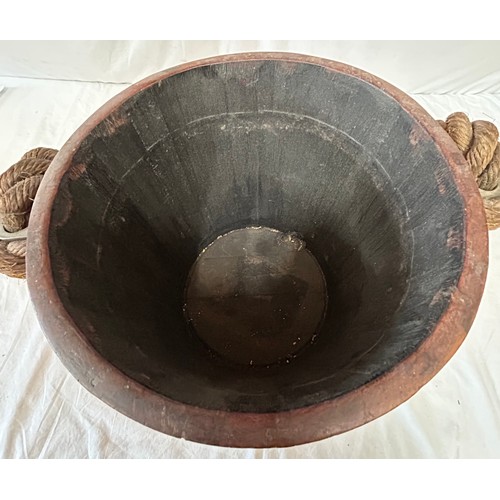 1172 - An oak naval fire bucket with insignia to the front, two copper bands and a rope handle with leather... 