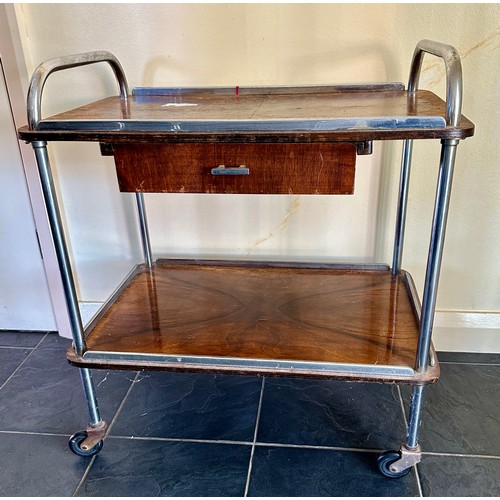 25 - A mid 20thC rosewood and chrome trolley on wheels with drawer. 70cm h, 63cm l x 41cm d.