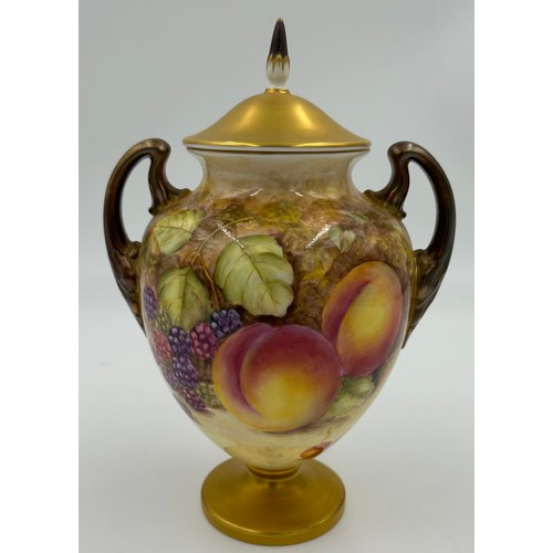 369 - A pair of Royal Worcester porcelain urn shaped vases painted with assorted fruit, one signed C. Hugh... 