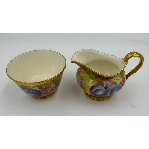 374 - A Royal Worcester sugar bowl 11.5cm d and milk jug 9cm h decorated with plums and berries on a moss ... 