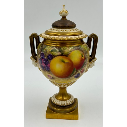 376 - A pair of Royal Worcester twin handled lidded urns with masks to sides on a circular foot with a squ... 