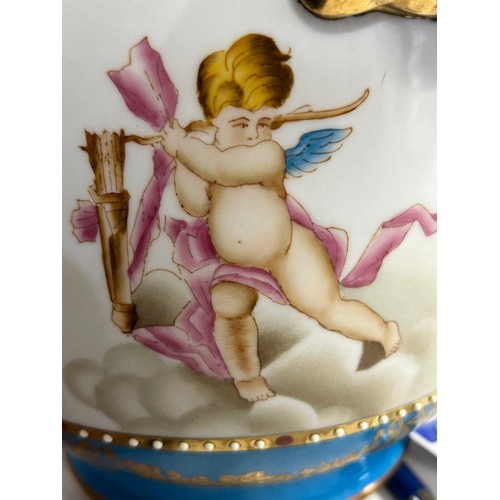 385 - A polychrome porcelain cache pot decorated with winged cherubs. Cross swords to base. 20cm h x 19cm ... 