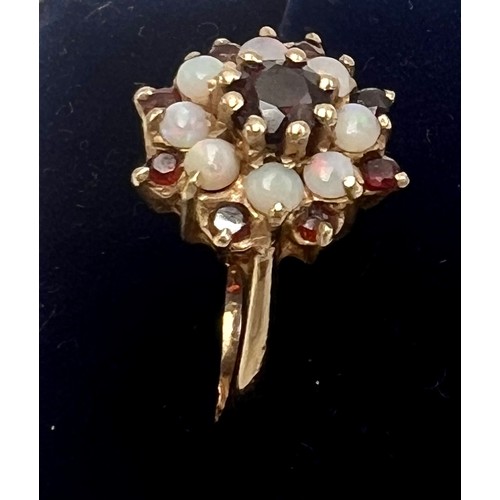 543 - A garnet and opal cluster ring set in 9 carat yellow gold. London 1974. Size M. Weight 3.4gm.