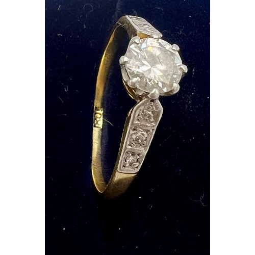 544 - A solitaire diamond ring set in 18 carat yellow gold with diamond set shoulders. Round brilliant cut... 