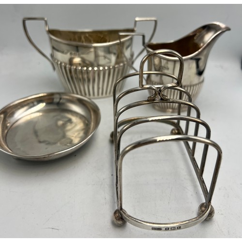 781 - Hallmarked silver to include toast rack Birmingham 1935, jug and bowl Sheffield 1902, maker James Di... 