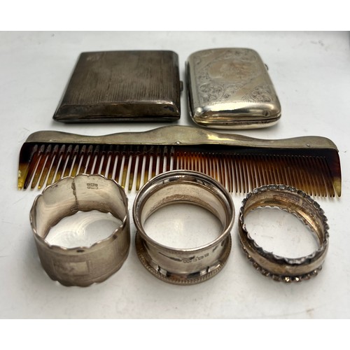 784 - Hallmarked silver to include three napkin rings, two cigarette cases and a silver mounted comb. Tota... 