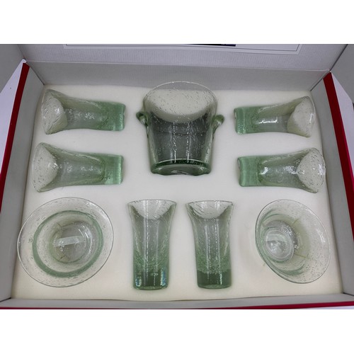 486 - A La Verrerie de Biot aperitif service in handmade blown green glass to include 6 x glasses 13cmh, i... 