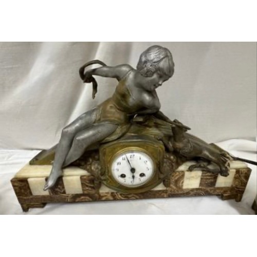 985 - An onyx mantel clock with a bronze figure of a girl and playing dog, marked Marseille, comes with ke... 