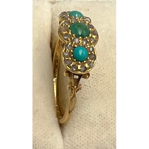 548 - An 18 carat gold ring set with turquoise and diamonds. Size P. Weight 2.6gm.