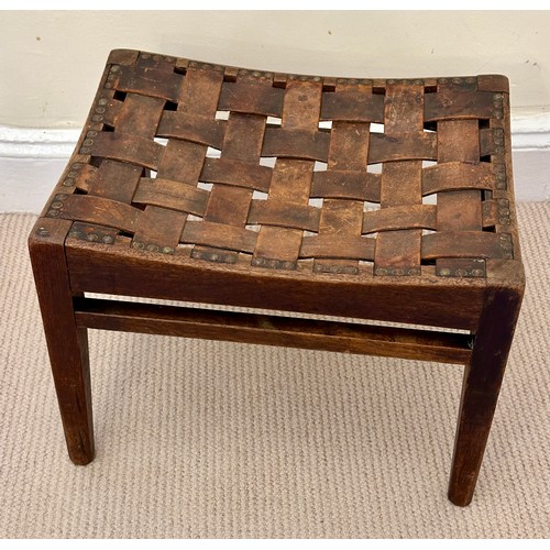 32 - Arthur W. Simpson, Kendal, an Arts and Crafts stool in oak, with original woven strap seat, and make... 