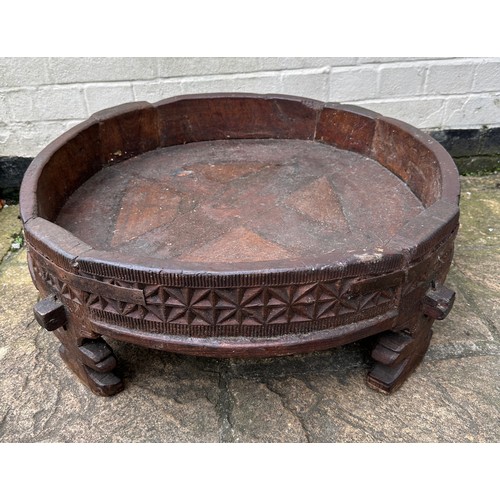 34 - An early 20thC Indian Chakki circular teak grinding table. Longest diameter 71cm w x 27cm h.