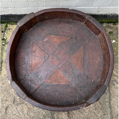 34 - An early 20thC Indian Chakki circular teak grinding table. Longest diameter 71cm w x 27cm h.