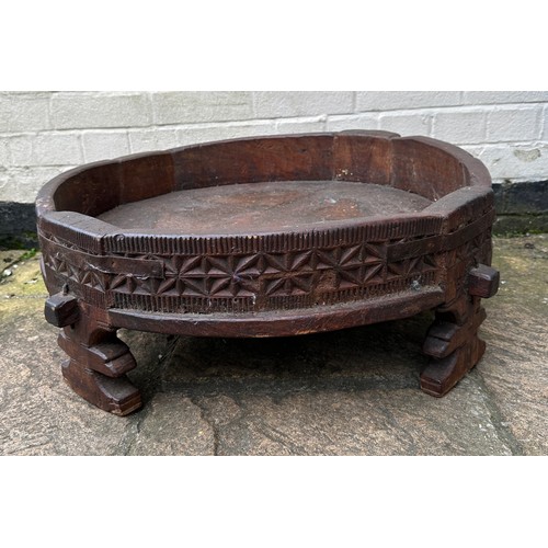 34 - An early 20thC Indian Chakki circular teak grinding table. Longest diameter 71cm w x 27cm h.